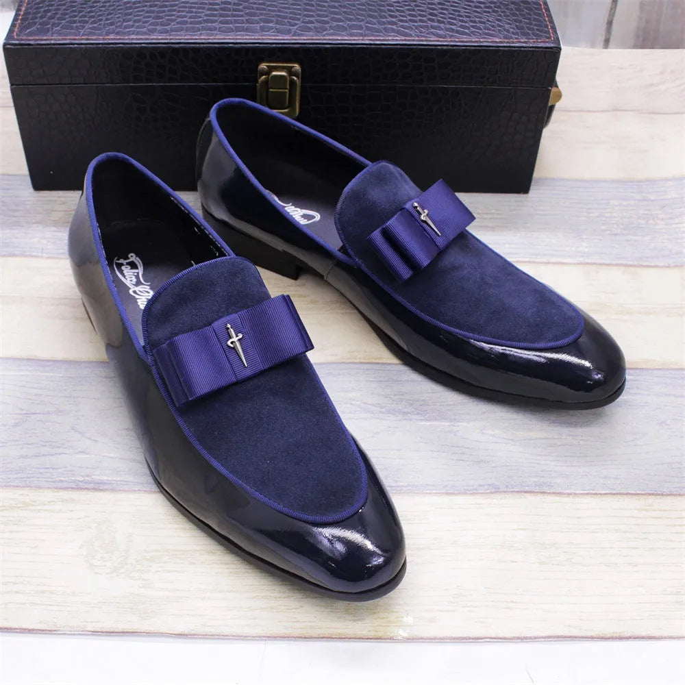 Men's glossy black patent leather low-top shoes with a tassel detail on a white background