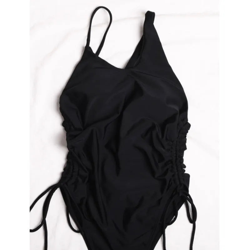 Black women's sleeveless dress with sloping shoulders and lacing detail