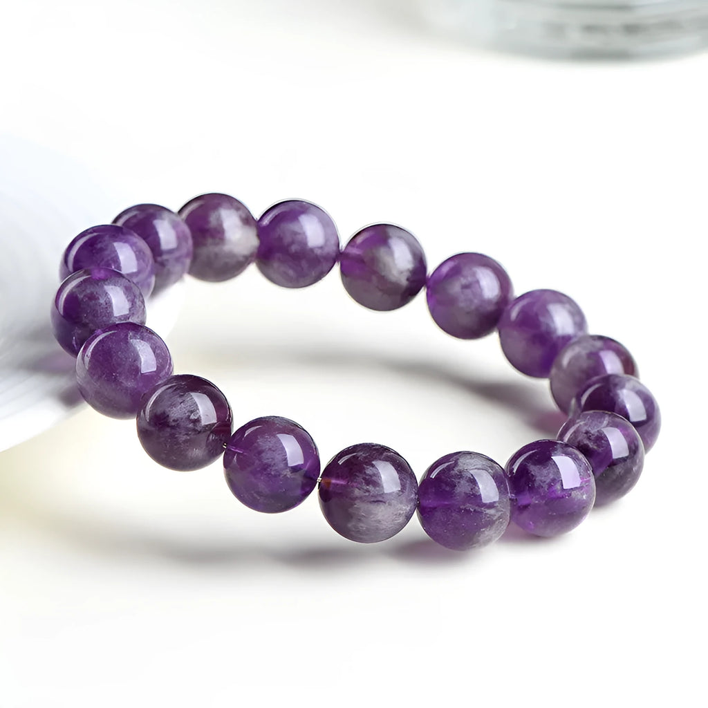 Natural feather amethyst crystal bracelet with scattered Snow Mountain purple beads and geometric Ruyi design.