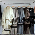 Women's light brown knit cardigan, vest, and loose trousers three-piece set laid flat.