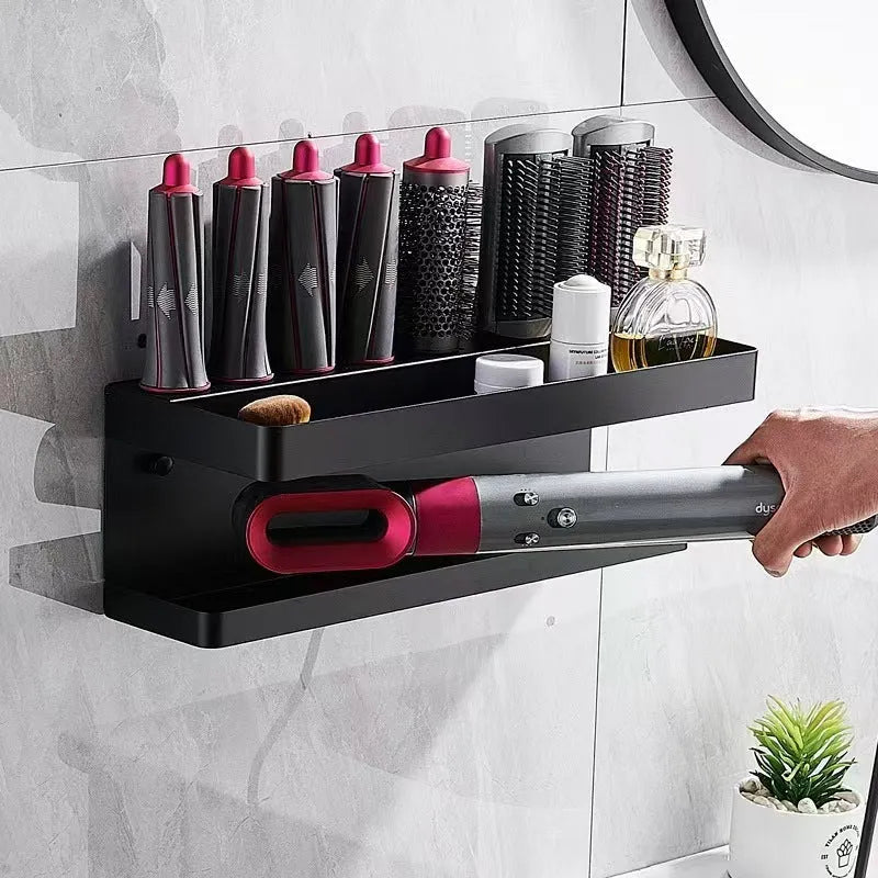 White double-layer aluminium bathroom storage rack mounted on a wall holding hair curlers.