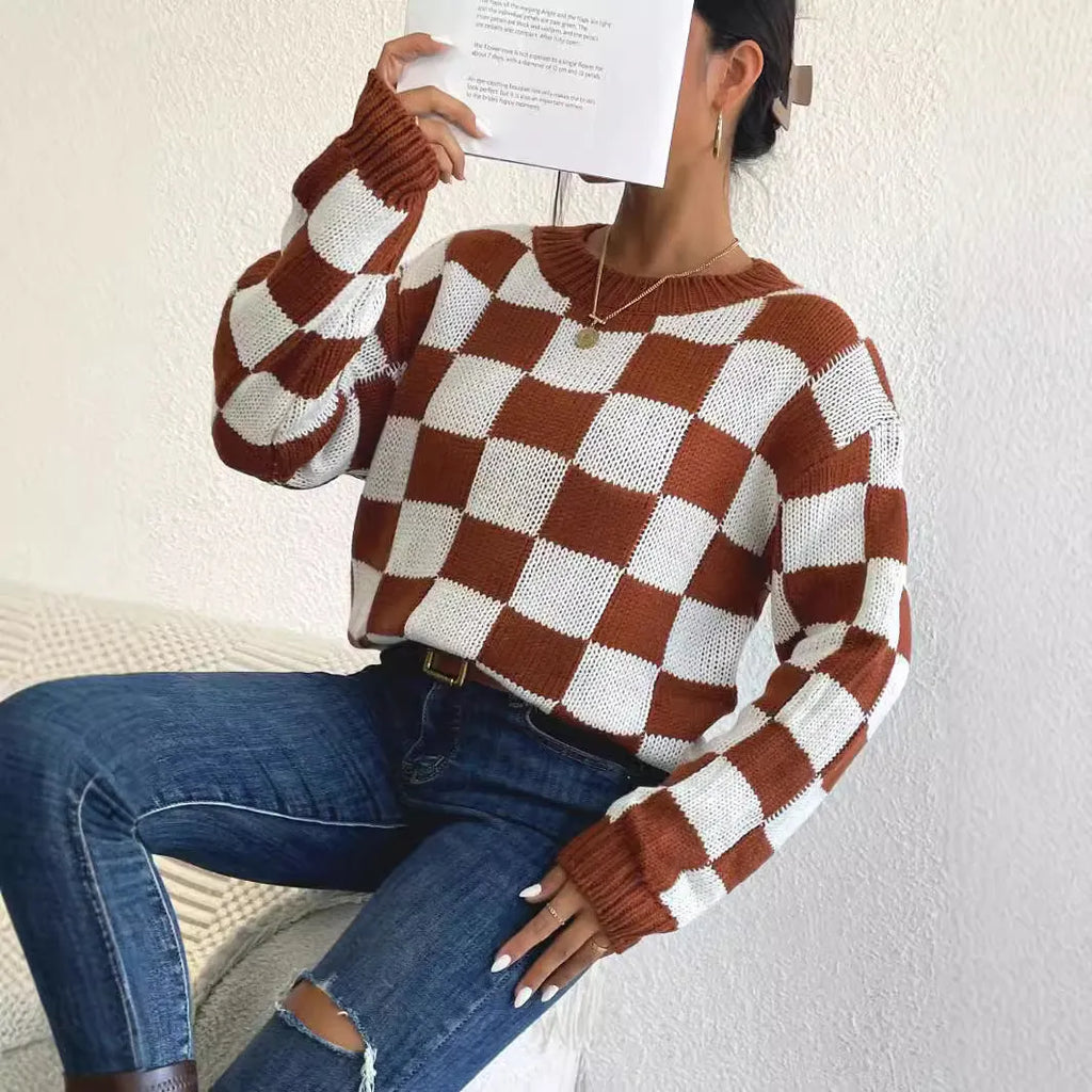 Dark brown loose-fit pullover sweater with a plaid chessboard pattern and long sleeves.