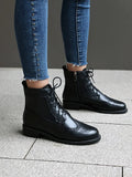 Women's black classic boots with chunky short stout heel, pointed toe, ethnic totem pattern, and middle calf length