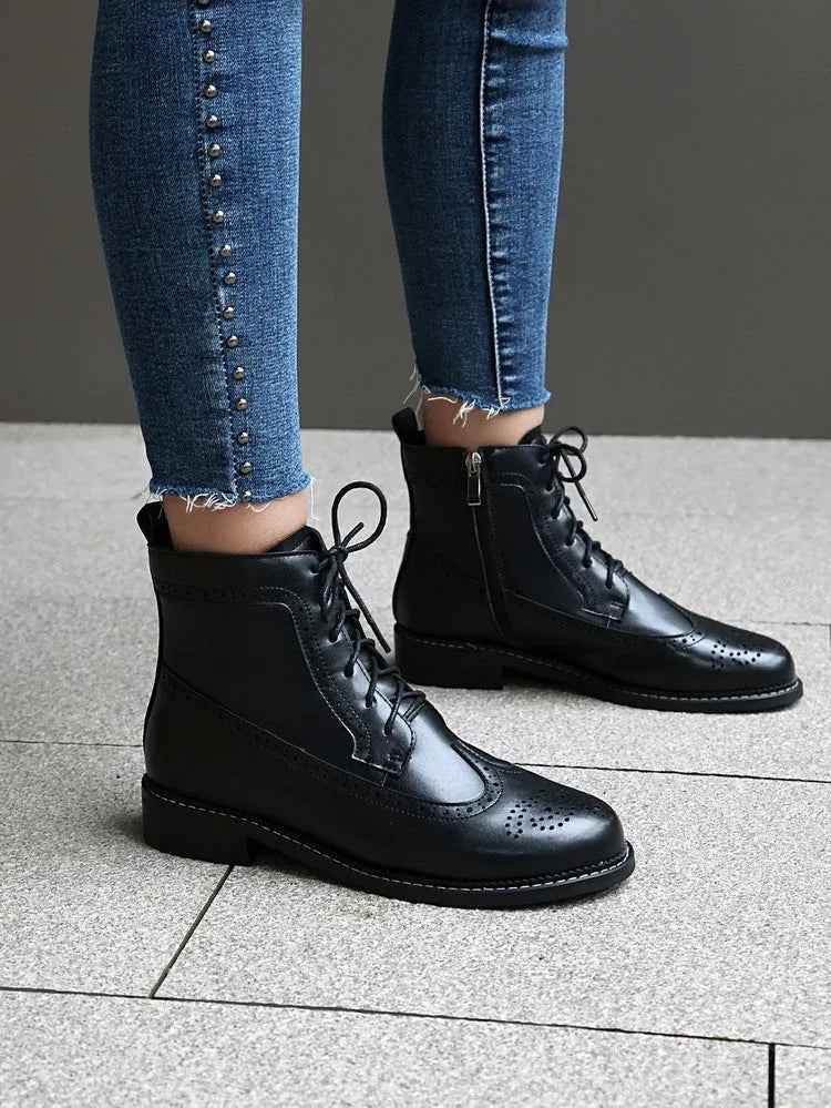 Women's black classic boots with chunky short stout heel, pointed toe, ethnic totem pattern, and middle calf length
