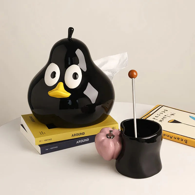 Green ceramic pear-shaped tissue box holder on wooden desk