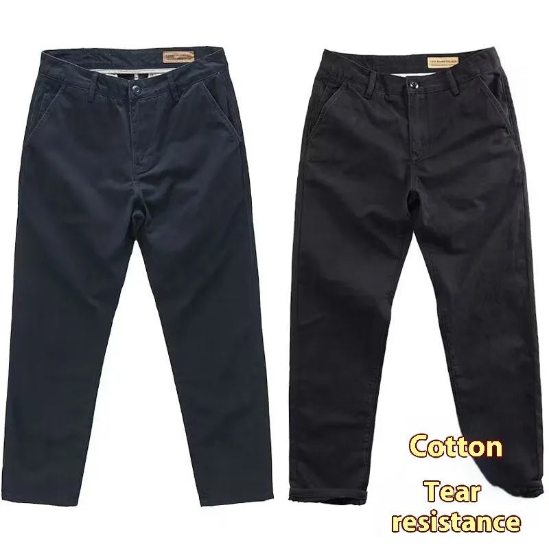 Man wearing slim-fit washed casual trousers in a neutral colour, showcasing the straight-leg style.