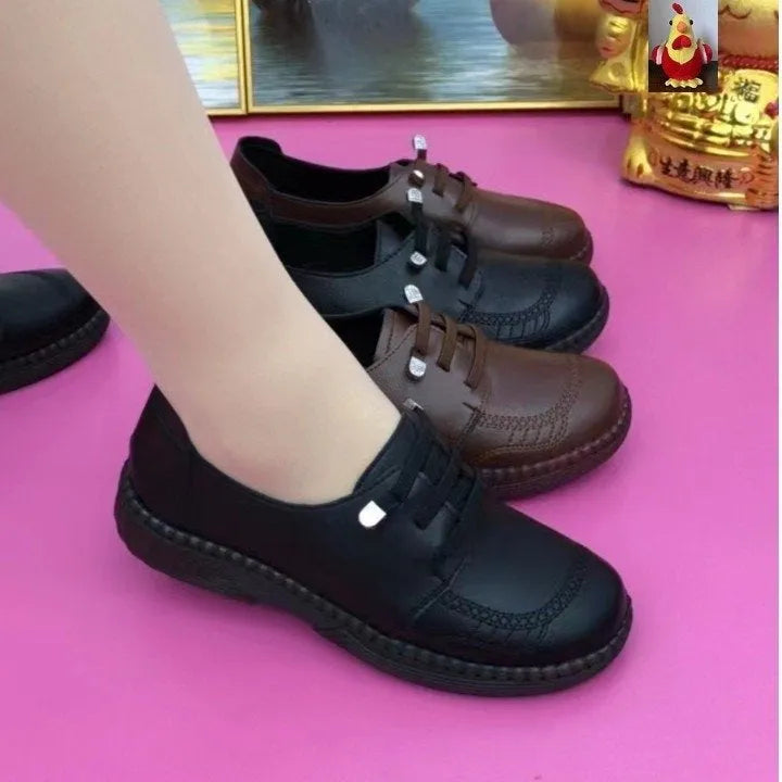 Women's soft leather low heel shoes in black with front lace-up and non-slip rubber sole