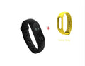 Xiaomi Mi Band 2 black fitness tracker on wrist showing OLED display with heart rate reading.