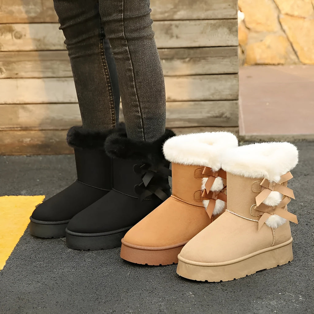 Women's suede ankle boots with fleece lining, flat heel, and bow detail in beige