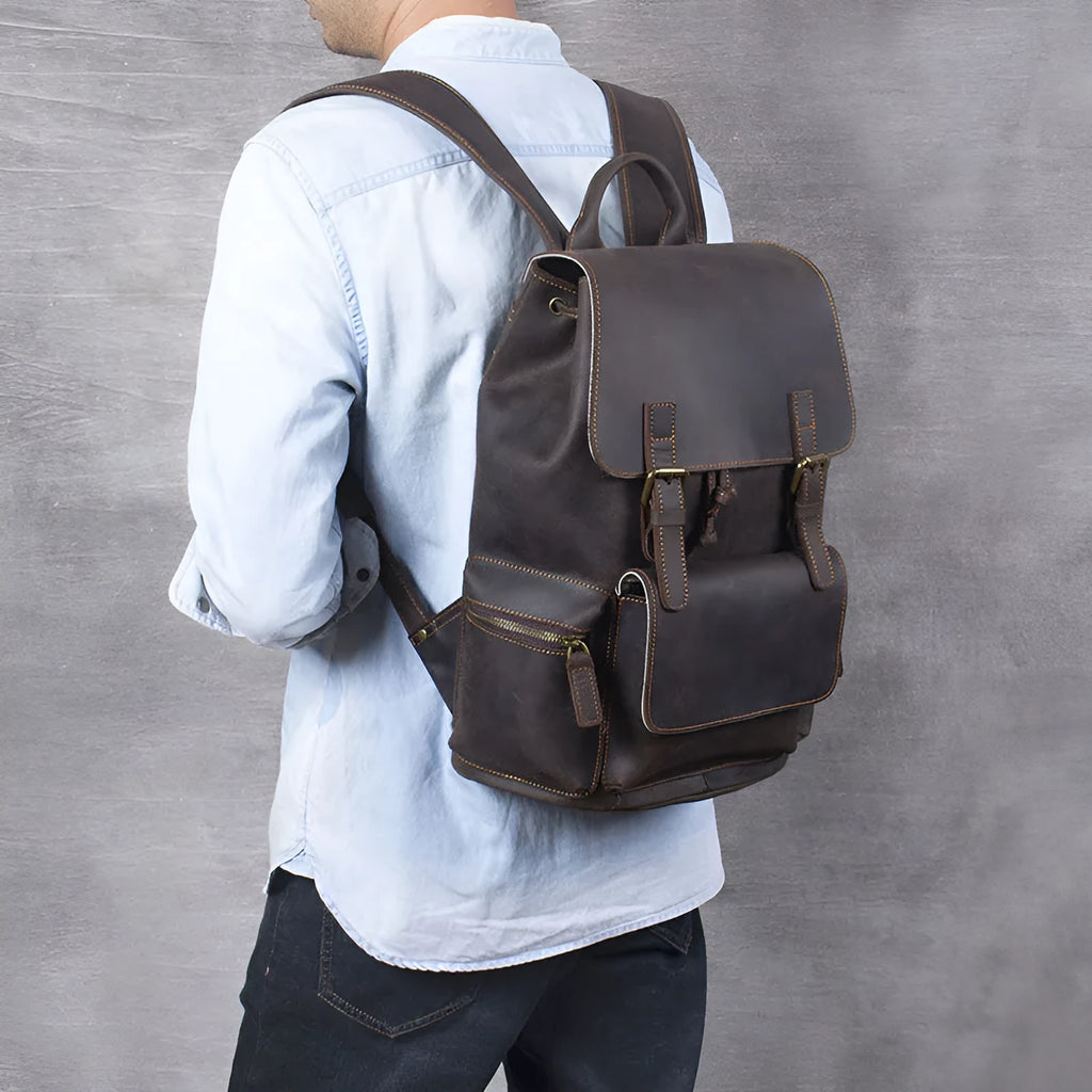 Brown retro-style leather backpack with shoulder straps, made from first layer cowhide with denim lining.