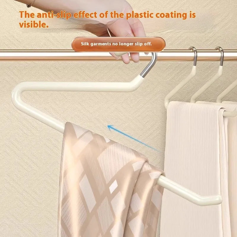 Non-slip Z-shaped trouser hanger in stainless steel dipped finish, shown in cream white, green and black
