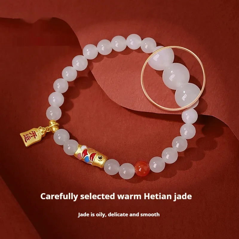 S925 sterling silver bracelet with a blue cold enamel and natural Hetian jade koi fish charm.