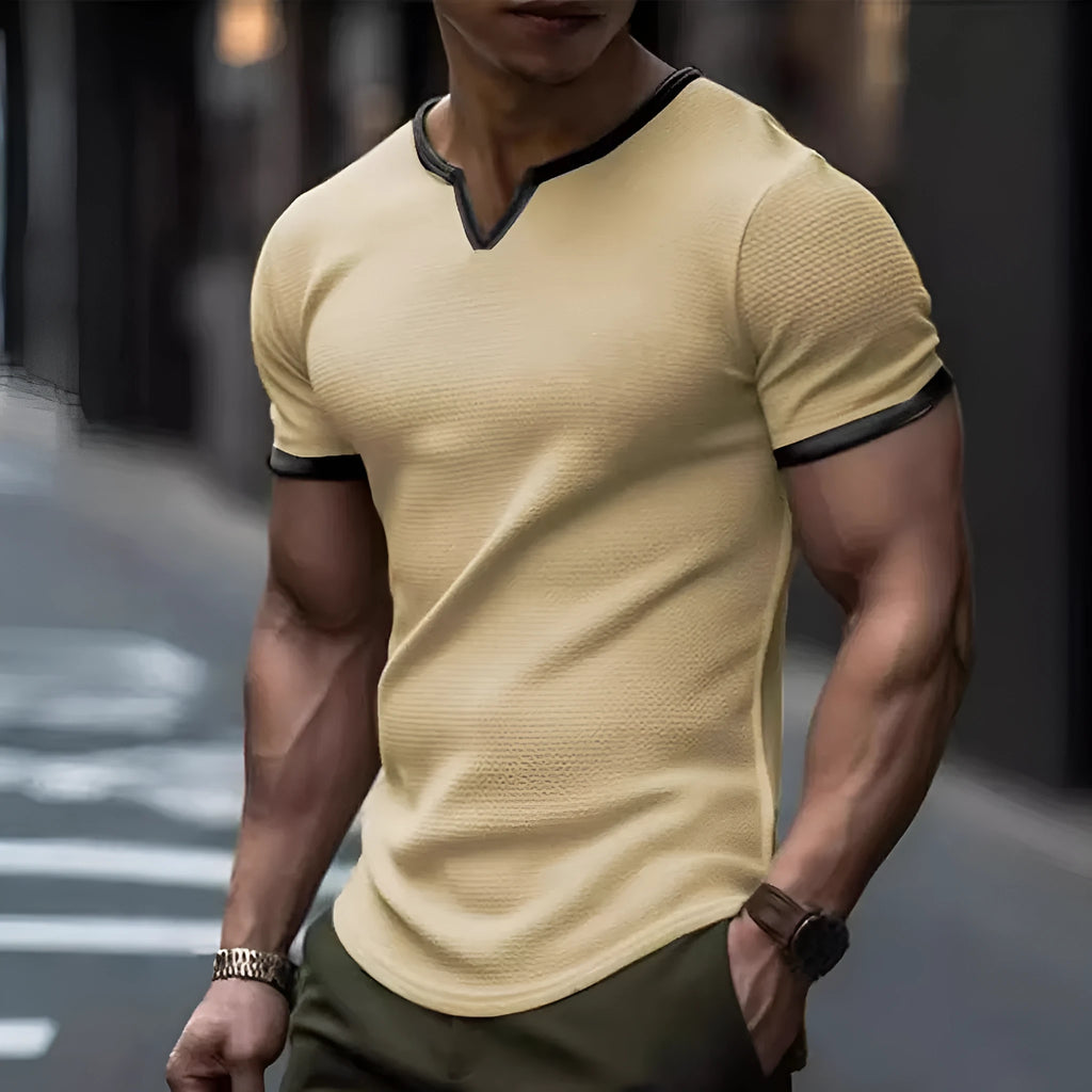 Colour-block waffle textured V-neck sports t-shirt in polyester on a size chart.