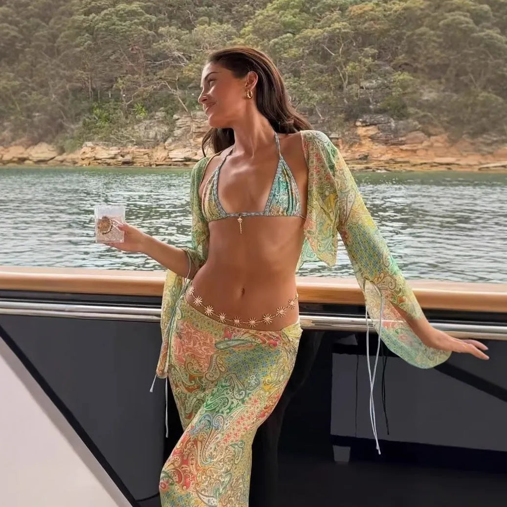 Green halterneck printed lace-up split swimsuit with long bell sleeves on a model