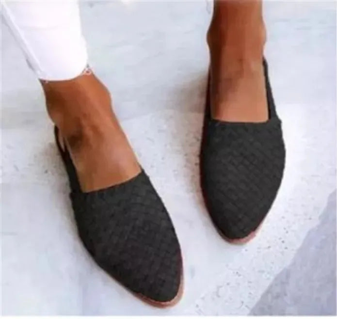 A pair of pointed toe, baotou flat sandals with a central buckle fastening, shown in a selection of colours.