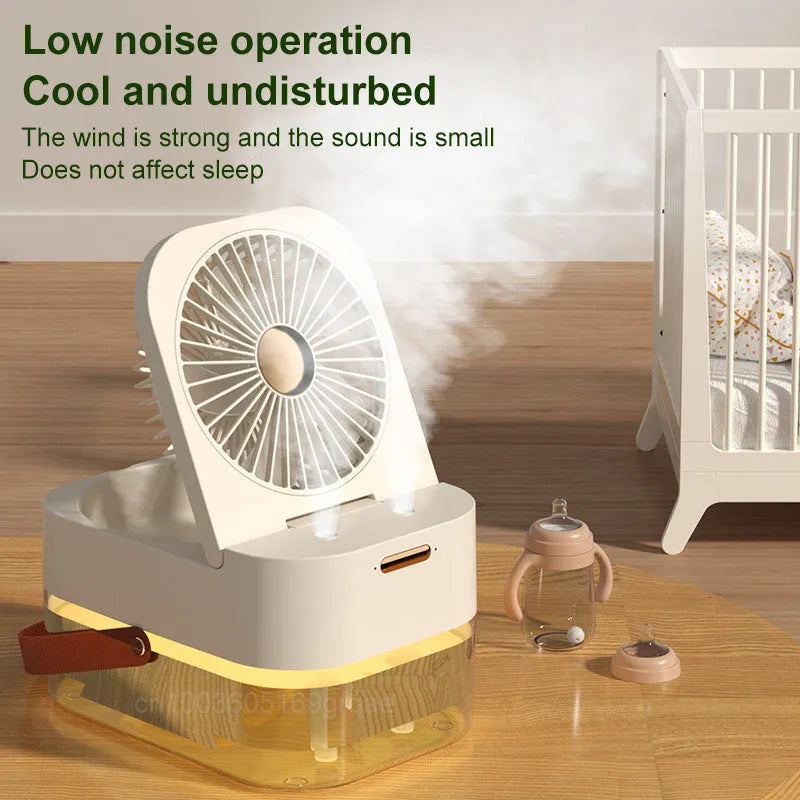 White or green USB desktop fan humidifier with remote control on a wooden desk.