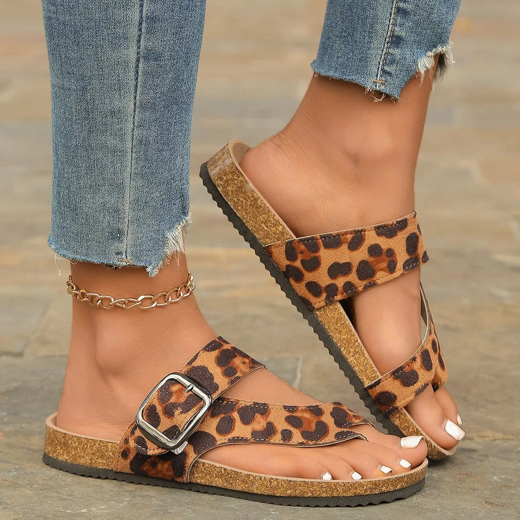 Leopard print Roman style slippers with rounded toe covering and wooden sole.