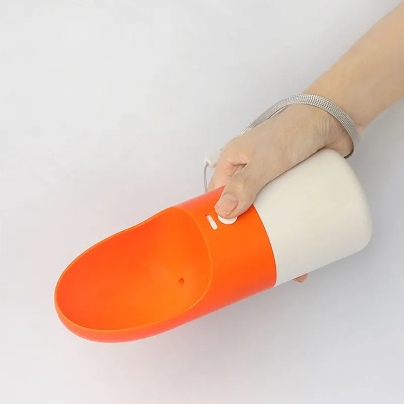 Moestar rocket-shaped pet drinking cup in white with grey or orange accents showing one-button lock mechanism