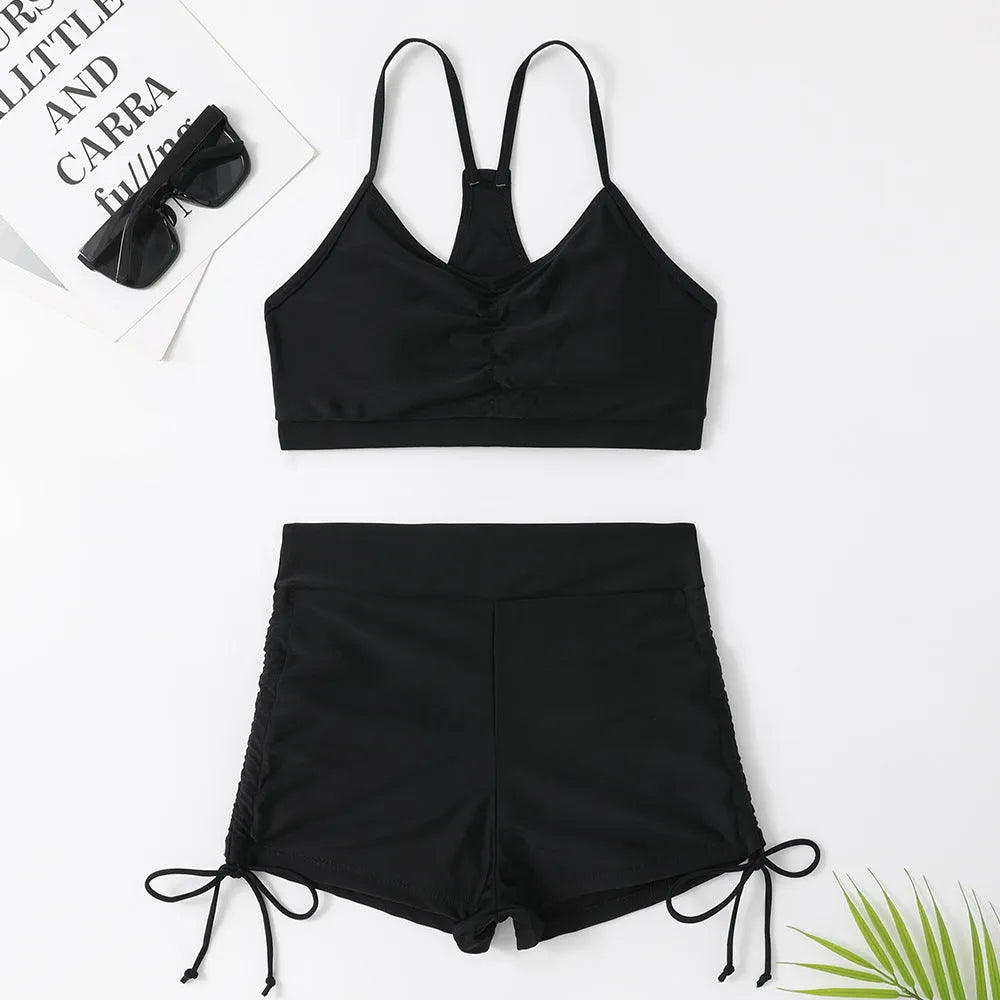 Purple and black women's high waisted bikini swimsuit with side splits.