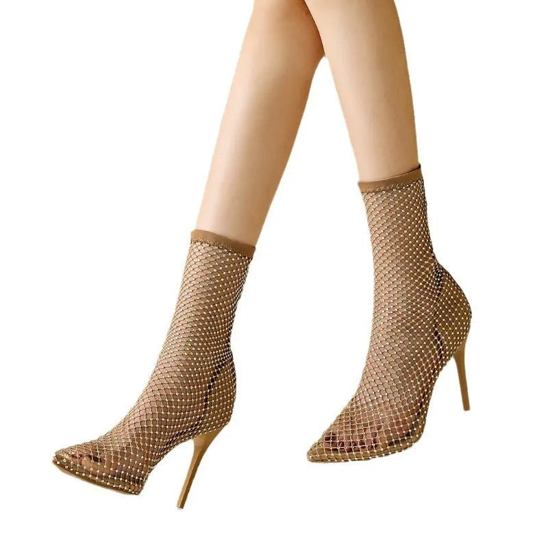 Metallic gold women's high heel sandals with a mesh oversleeve design and pointed stiletto toe.