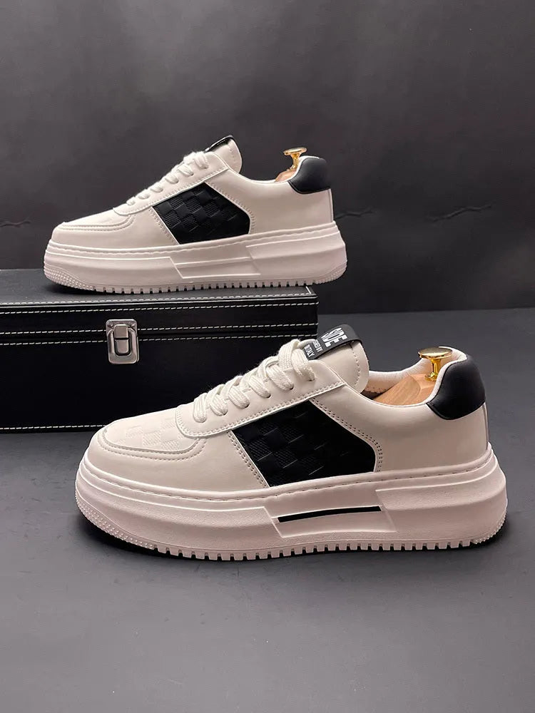 A pair of unisex casual shoes in white with green trim, featuring a cloth upper and rubber sole.