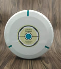 Black and white automatic robot vacuum cleaner on a wooden floor.