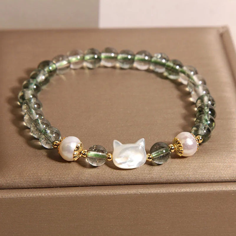 Green phantom quartz bracelet with shell kitten charm on wrist