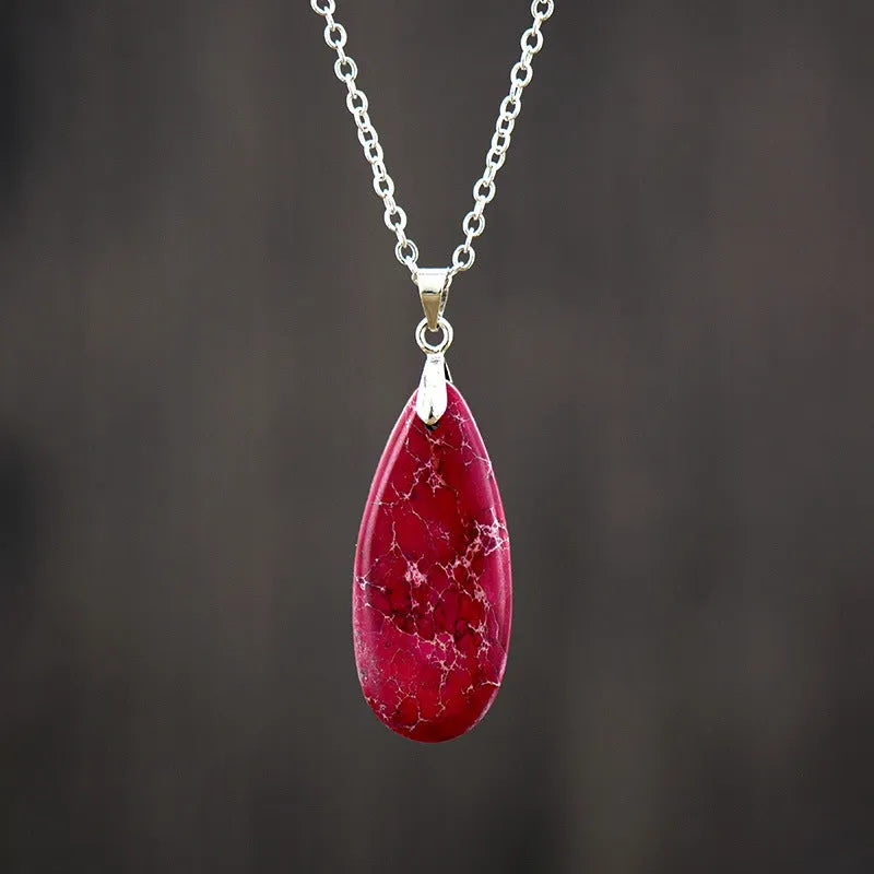 Emperor Stone jade pendant necklace on a gold chain, showing hand-carved detail and a lobster clasp.