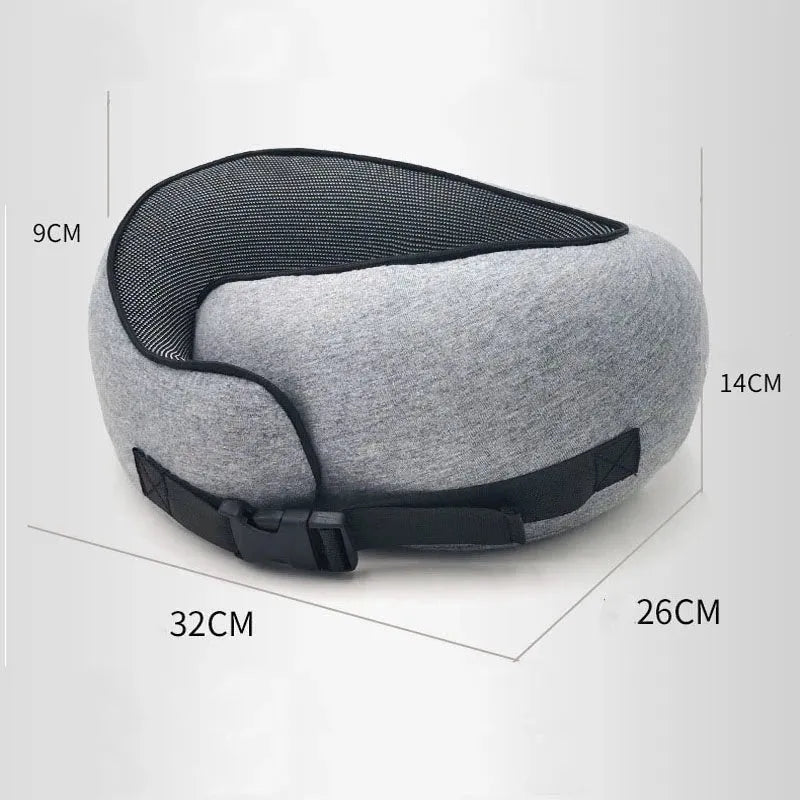 Navy blue memory foam U-shaped travel neck pillow rolled up next to its carry bag