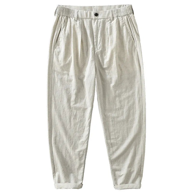 Man wearing loose straight-leg trousers in a cotton linen blend, showing the retro Japanese style in a brown colour.
