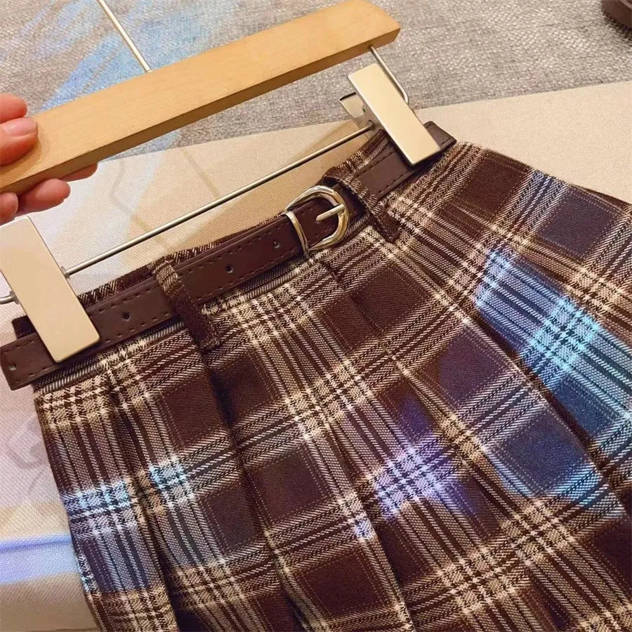 Children's plaid patterned pleated A-line skirt in cotton blend fabric.