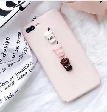 Soft pink silicone iPhone case with a raised 3D cartoon cat design, shown fitted on a phone.