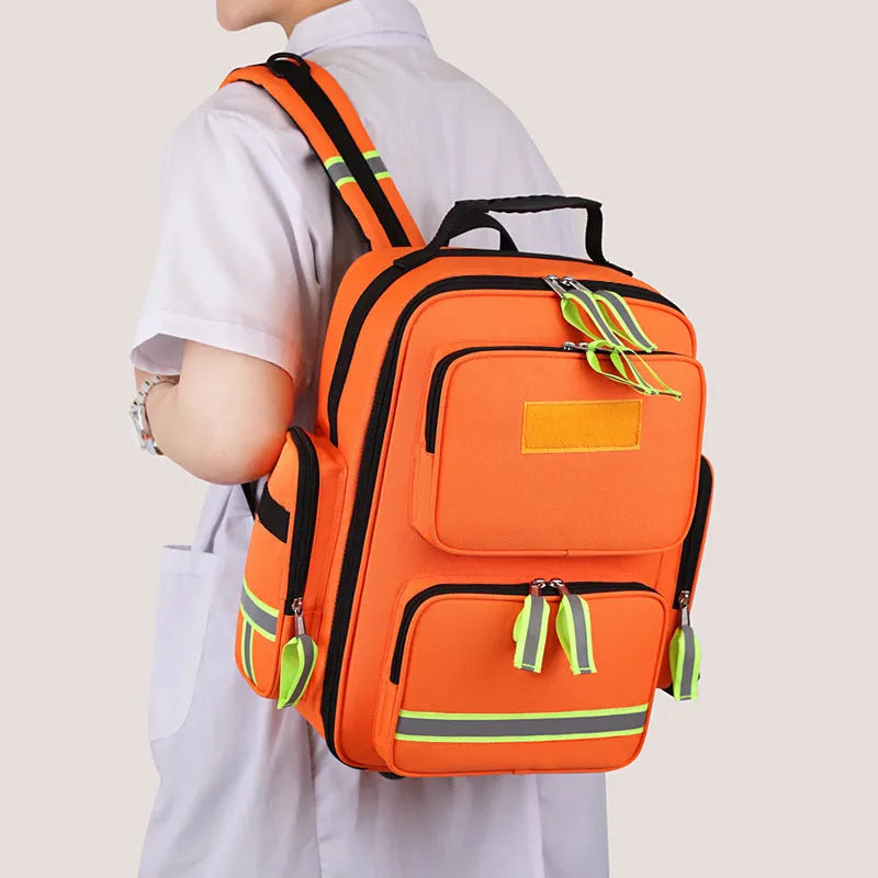 Large capacity empty first aid kit backpack in orange, made from waterproof Oxford cloth with reflective strips and multi-layer storage