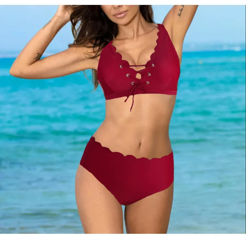 Red high-waisted women's two-piece swimsuit with a gathering split detail on a mannequin.