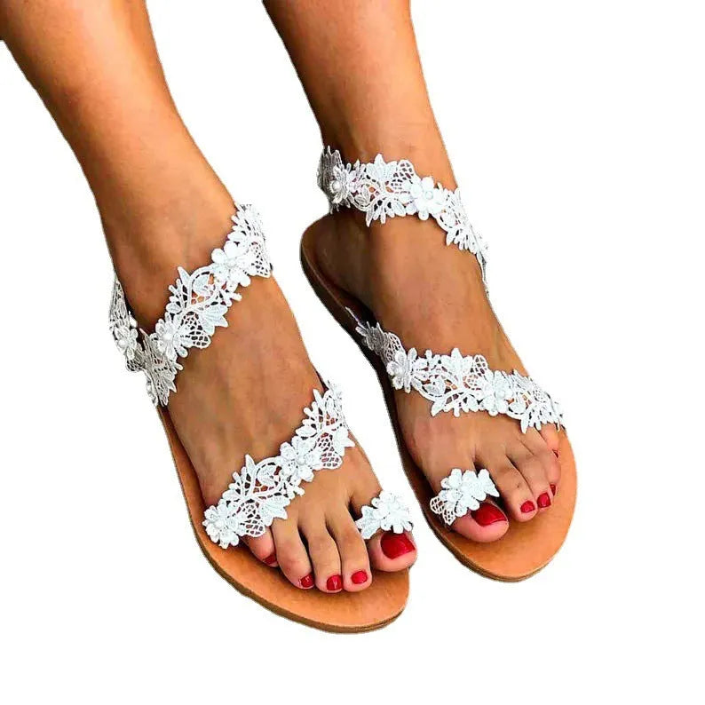 White plus-size women's flat shoes with rhinestone and floral decorations on patent leather.