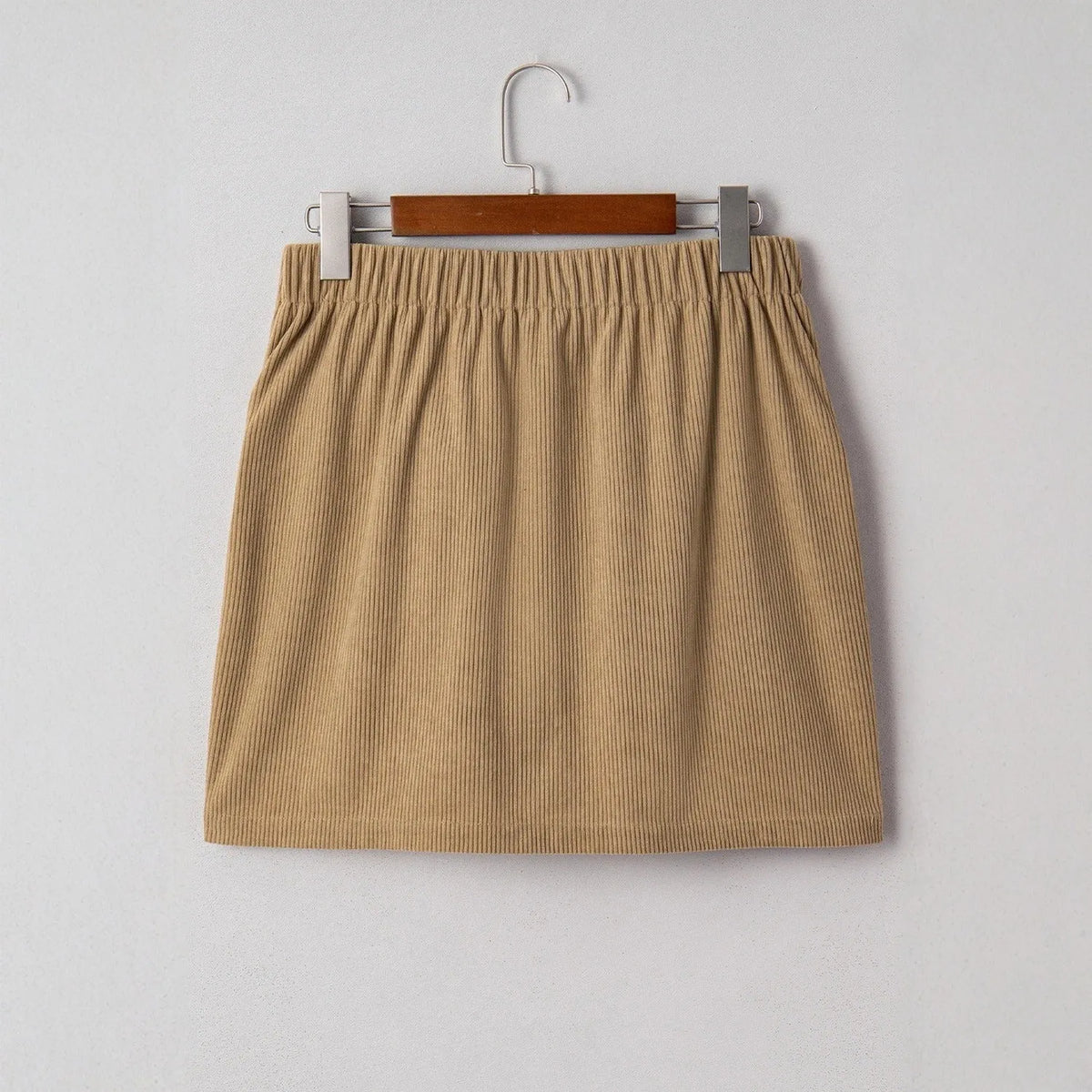 Women's corduroy hip skirt in solid coffee colour, short street-style design with button detail, sizes S to XL