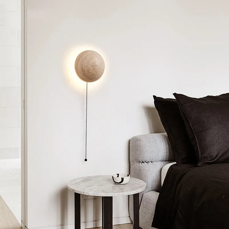 Vintage semicircle wall lamp with a yellow cave stone shade and iron base, showing the pull switch.