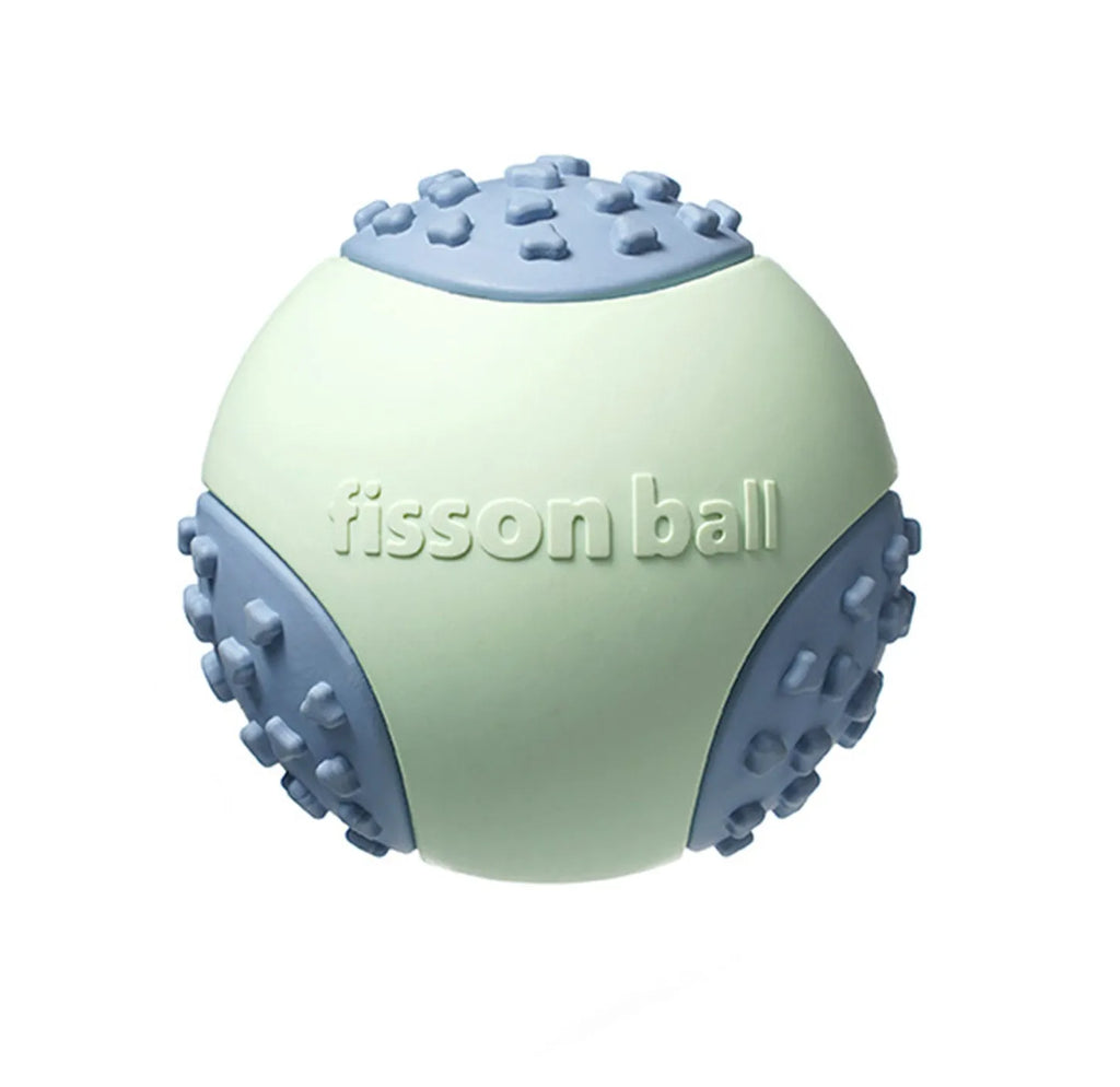 Green rolling ball dog toy for small medium breeds on a floor.