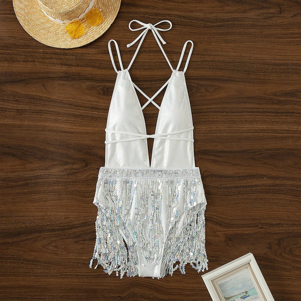White women's deep V-neck one-piece swimsuit with tassel trim on brief-style bottom