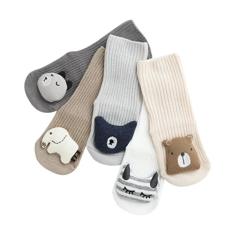 Pair of light grey baby socks with white non-slip silicone grip dots on the soles.