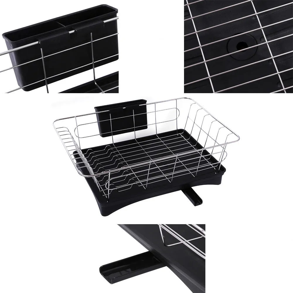 Black stainless steel dish drying rack with cutlery holder and drainboard on a kitchen counter.