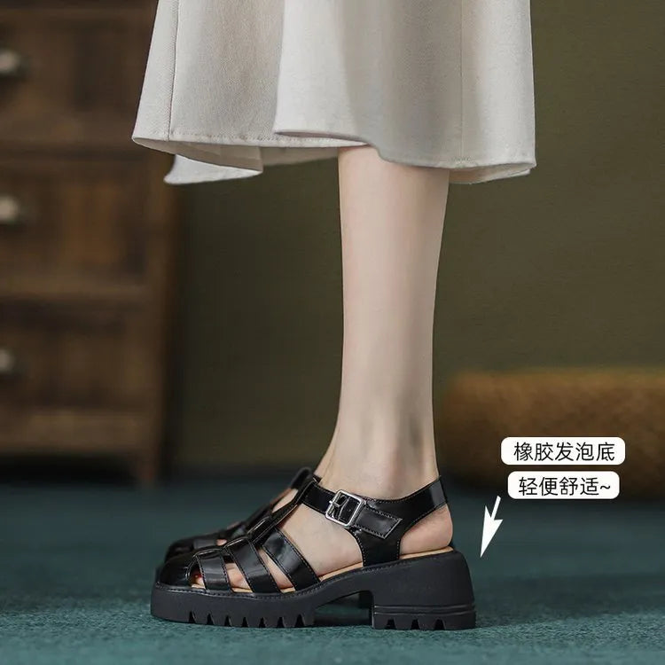 Women's black retro platform sandals with a chunky heel, closed toe, and buckle fastening.