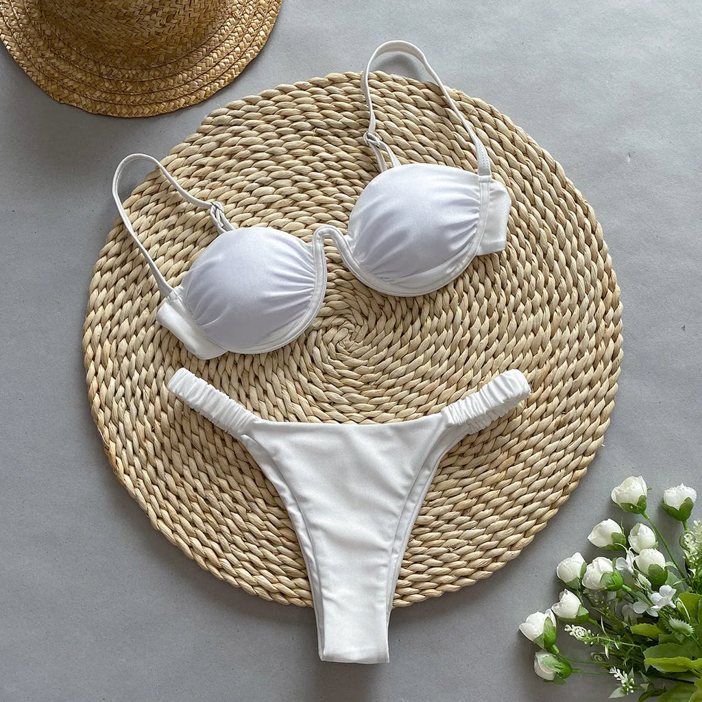 Women's black underwire bikini swimsuit set on a model, showing brief-style fit.