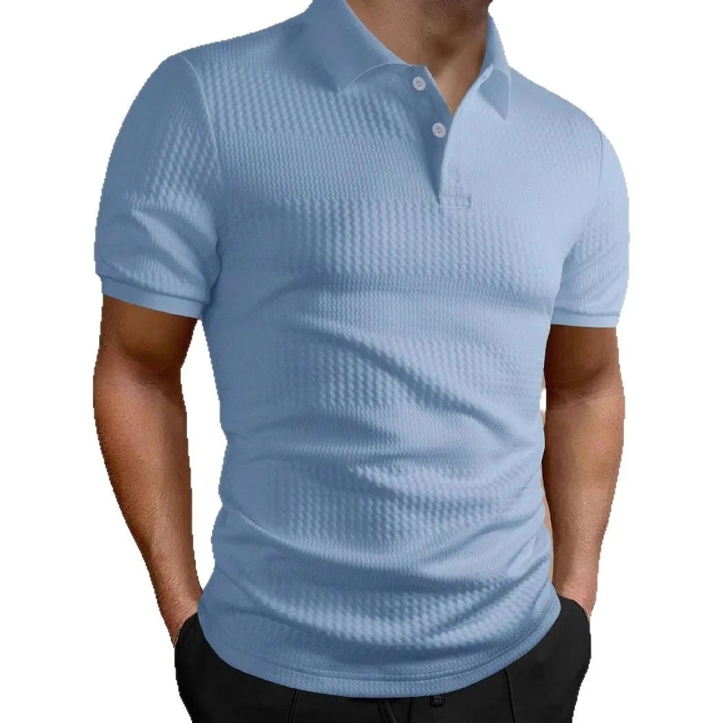 Man wearing a loose-fit striped polo shirt in a light blue colour, showing asymmetric detail and short sleeves.