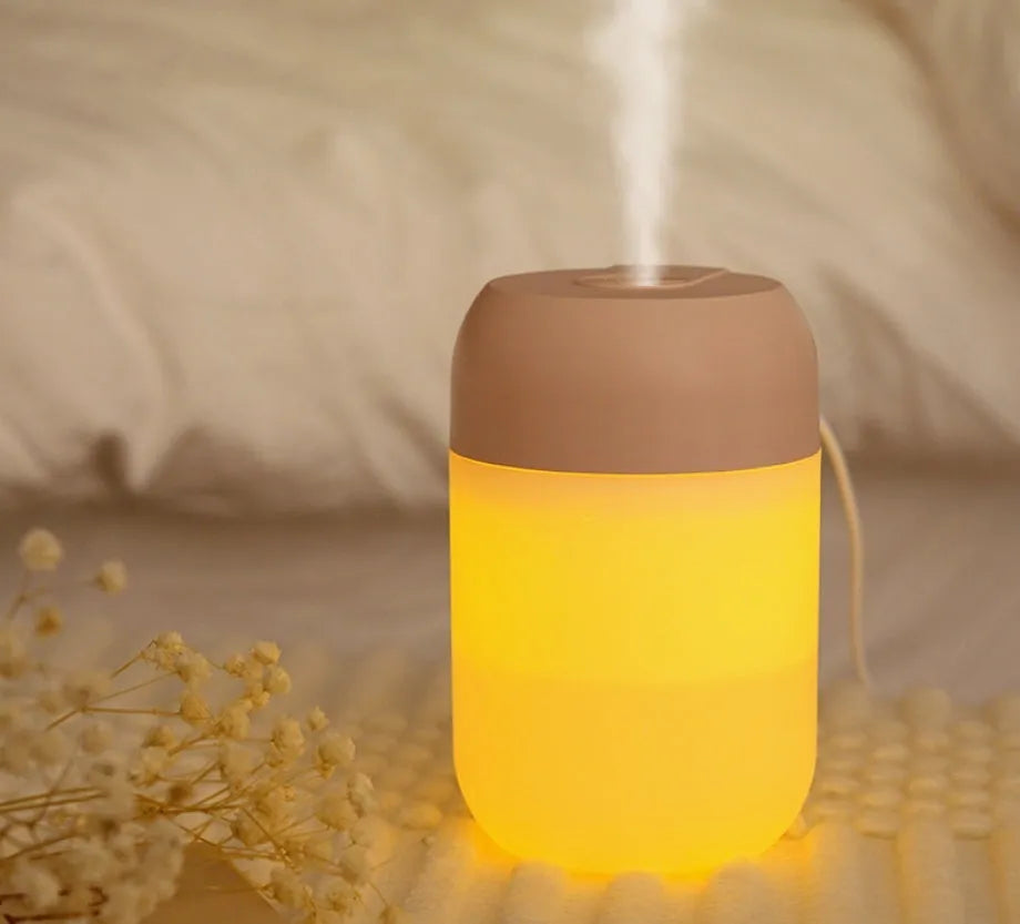 Small white cylindrical USB humidifier for desktop aromatherapy and humidification.