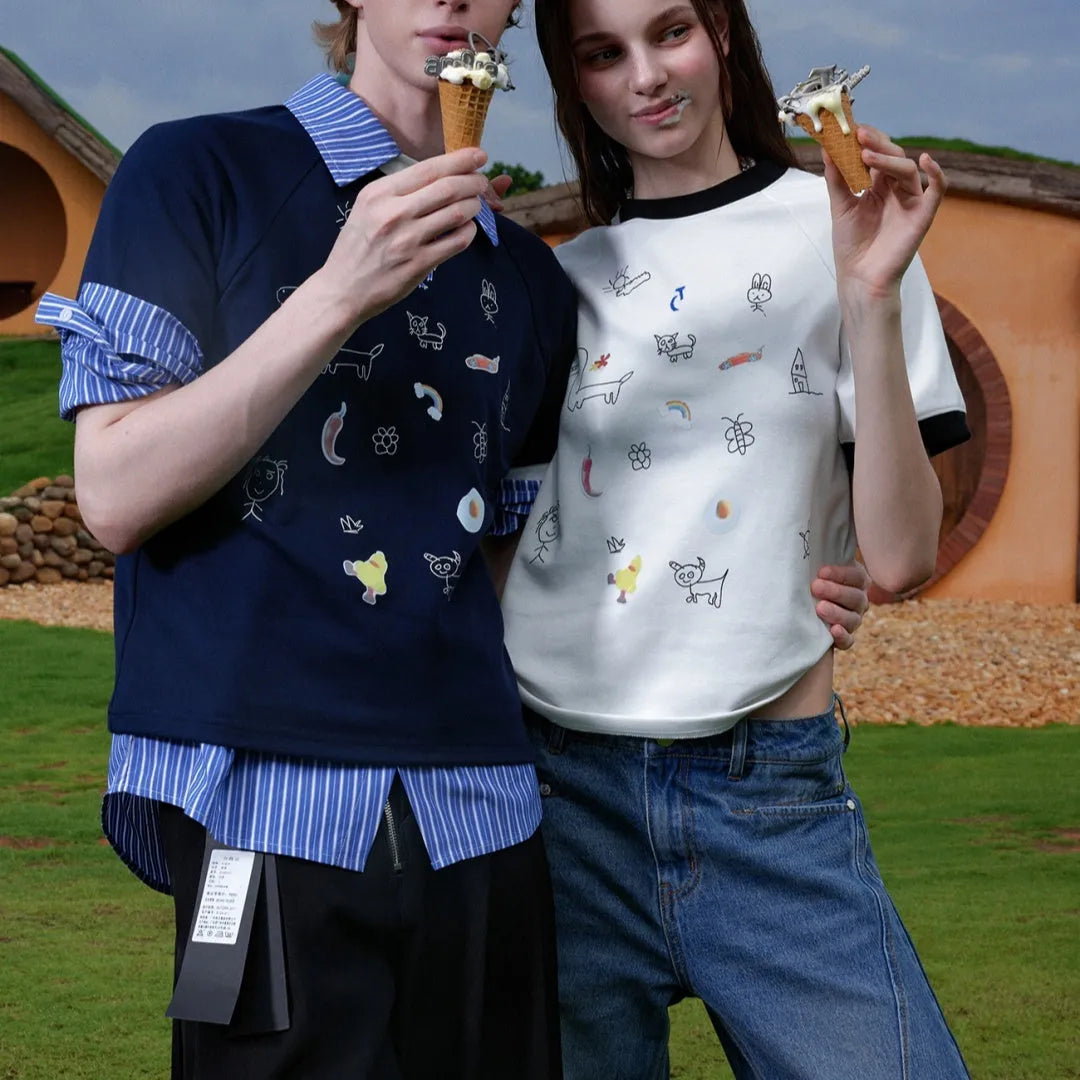 Man modelling a loose fit blue short sleeve shirt with a cartoon graphic print and contrast colour panels.
