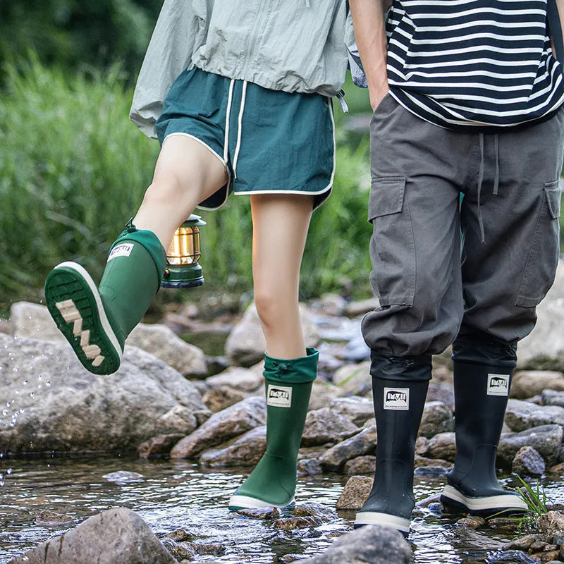 PVC waterproof high tube rain boots in beige, black, green, and red colours on a white background.