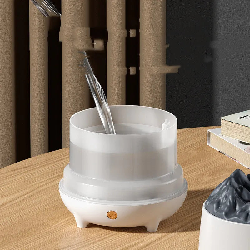White volcano-shaped ultrasonic humidifier with USB cable on a table