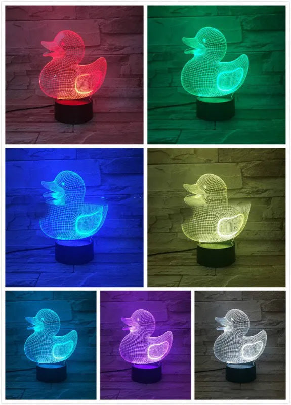 Yellow 3D duck-shaped LED night light with remote control on a table, showing soft multi-coloured glow.