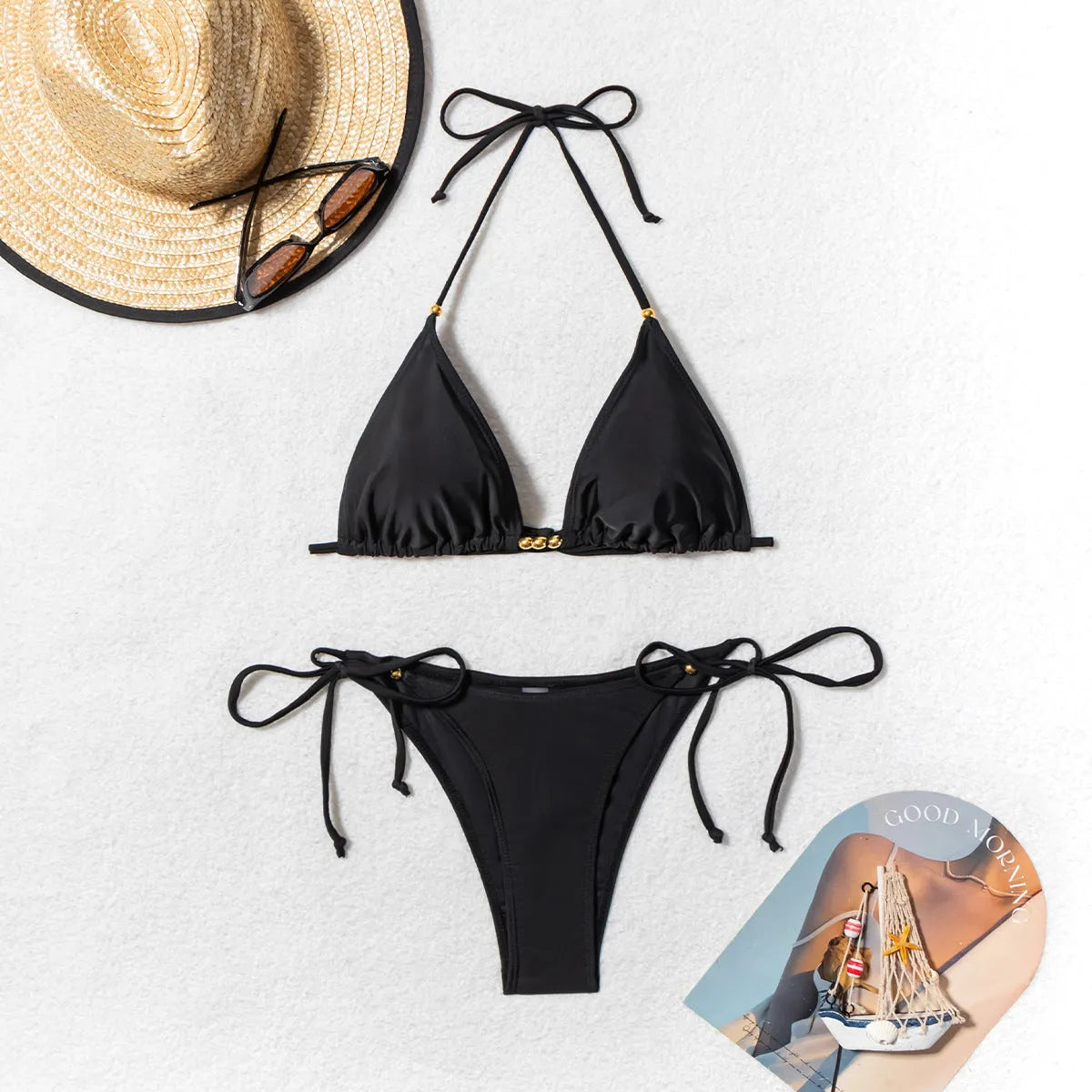 Black women's two-piece bikini swimsuit with metal bead decoration on the top.